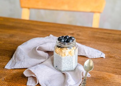 Healthy chia pudding with blueberries and coconut on a rustic wooden table. Perfect for breakfast.